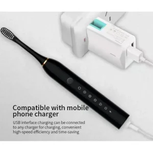 Electric Toothbrush — USB Charging Black sonic electric toothbrush plugged into a USB phone charger, showing its touch controls — Electromart Uganda