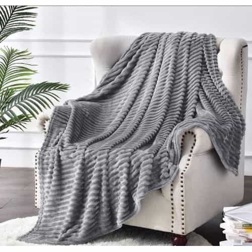 Flannel Fleece Throw Blanket (Grey) — Draped On Chair Grey ribbed flannel fleece throw blanket draped over a cream accent armchair — Electromart Uganda