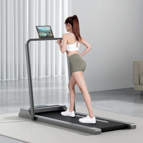 Under-desk walking pad treadmill with a folding handrail, in use with a tablet — Electromart Uganda
