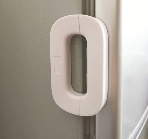 White adhesive fridge door child safety lock fitted on a refrigerator — Electromart Uganda