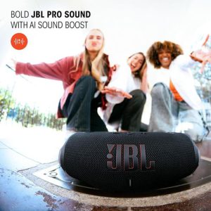 JBL Charge 6 Bluetooth Speaker — Black JBL Charge 6 portable Bluetooth speaker in black on the ground with friends dancing behind — Electromart Uganda
