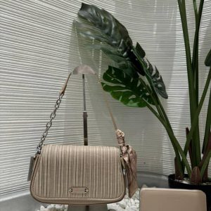 Taupe ChrisRosy slim crossbody flap bag on a stand with a matching wallet by a plant — Electromart Uganda