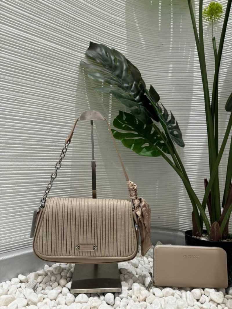 Taupe ChrisRosy slim crossbody flap bag on a stand with a matching wallet by a plant — Electromart Uganda
