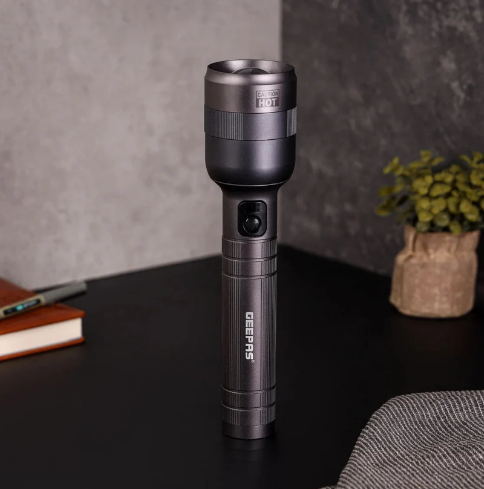 Geepas rechargeable metal flashlight torch in grey on a table — Electromart Uganda